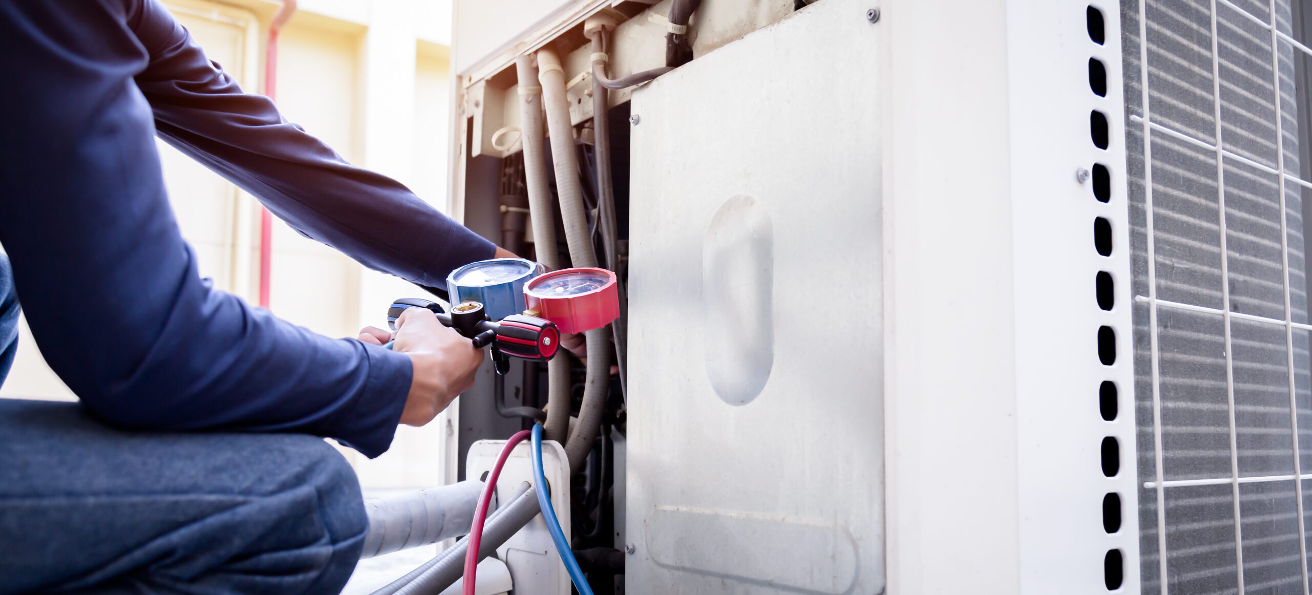 Technician is checking air conditioner ,measuring equipment for