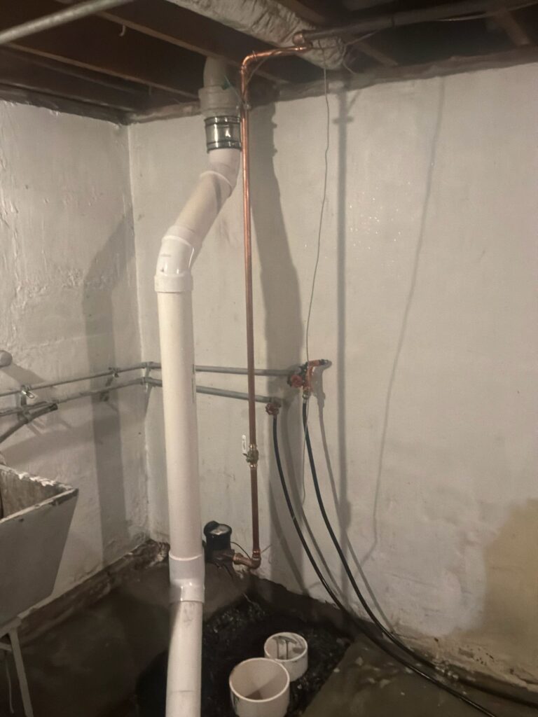 Excavated trap and deteriorated piping exposed beneath concrete floor during sewer line repair by Cellino in Cheektowaga, NY.