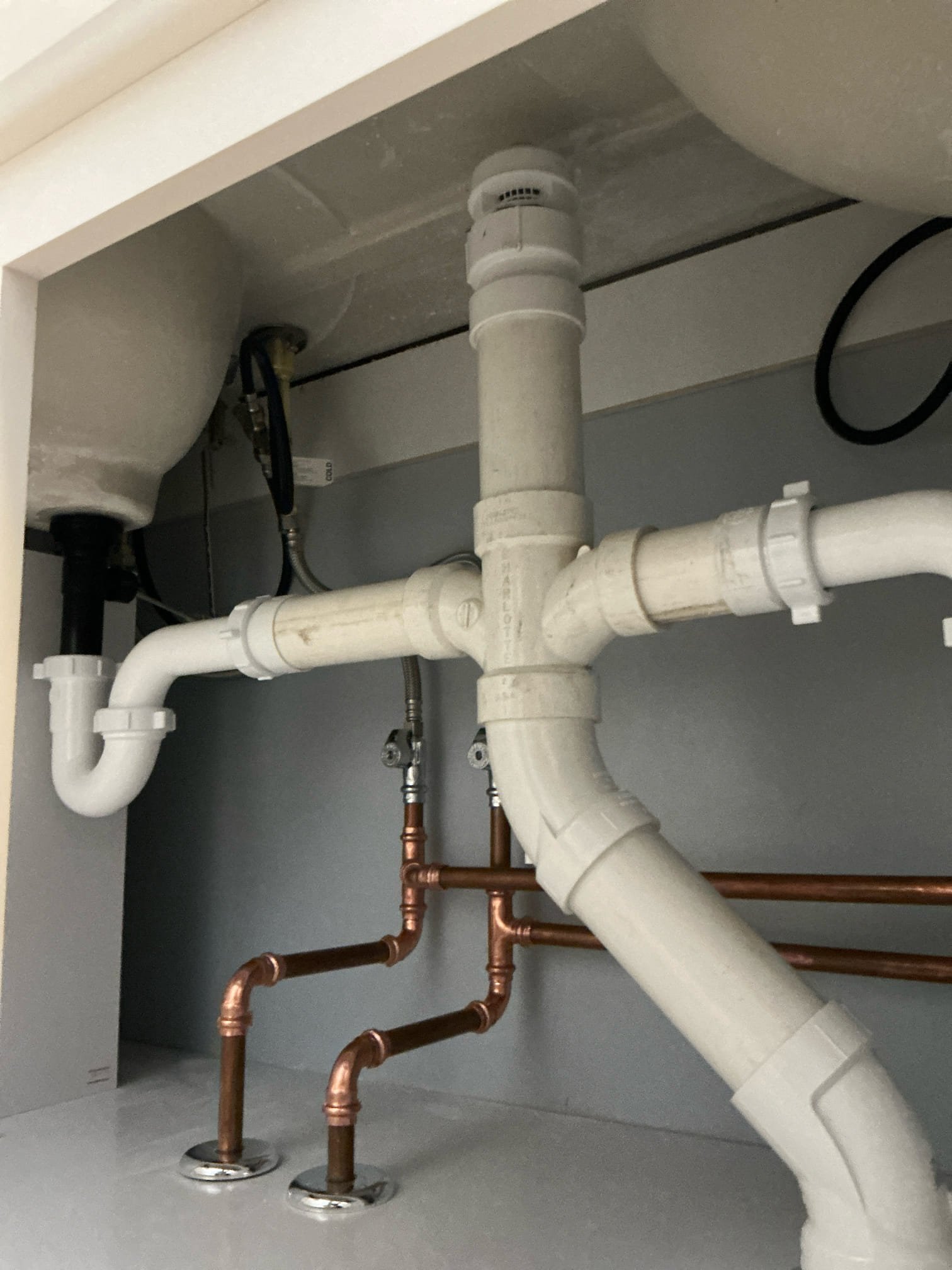 New PVC drain lines and Uponor PEX water supply lines roughed in for sink configuration in Williamsville, NY bathroom.