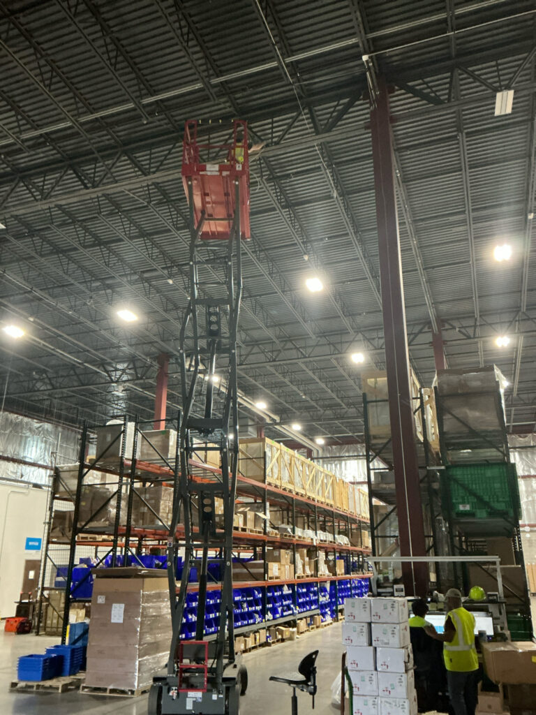 Commercial facility interior showing existing high bay lighting before LED upgrade by Cellino in Buffalo, NY.