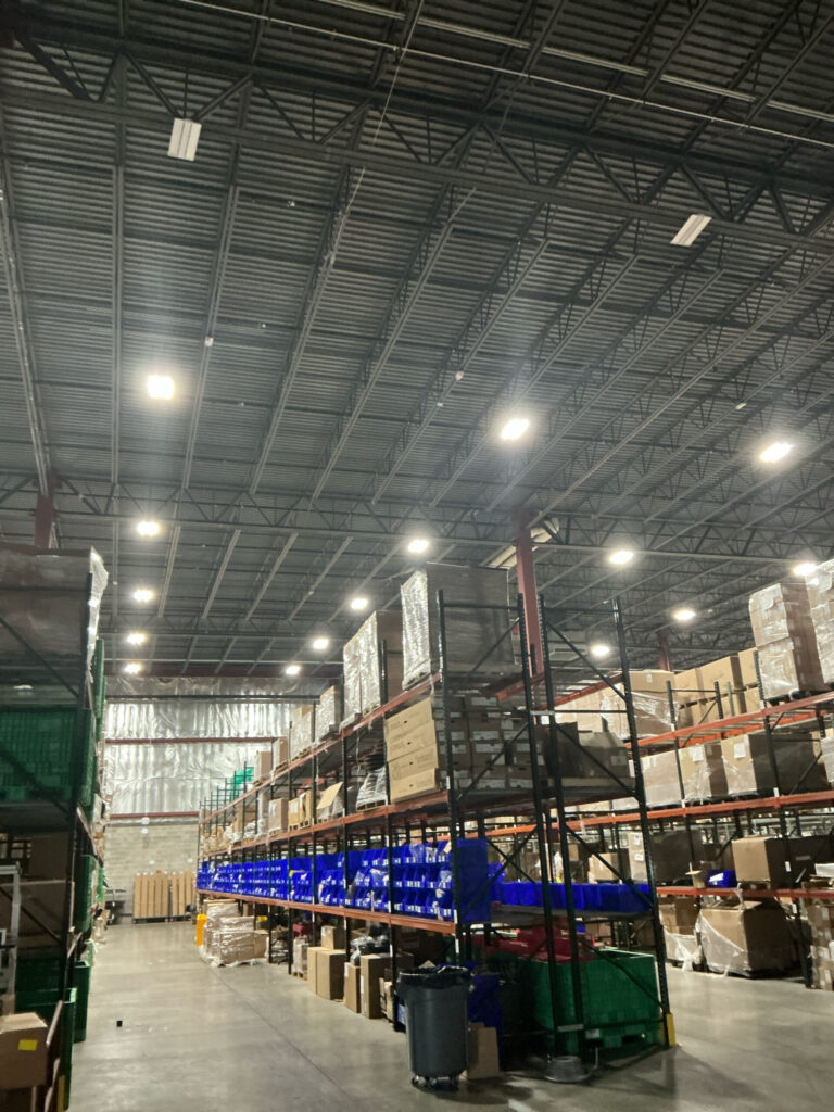 Commercial facility interior showing existing high bay lighting before LED upgrade by Cellino in Buffalo, NY.